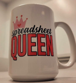 Coffee mug with text on it that reads Spreadsheet Queen